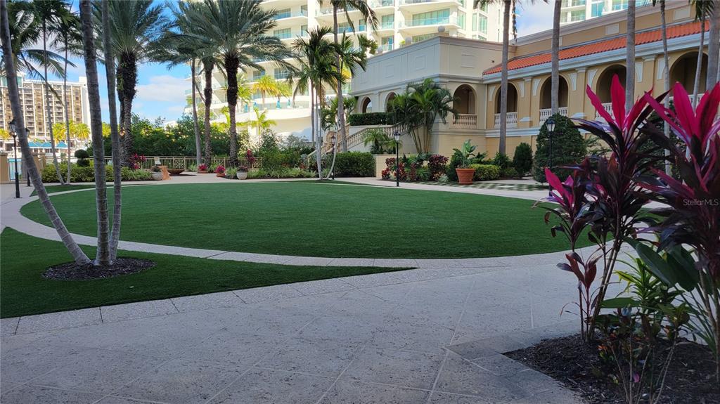 1111 Ritz Carlton Drive, Unit 1404 Sarasota, FL 34236 - Photo 60 of 69 a view of a house with a yard and palm trees