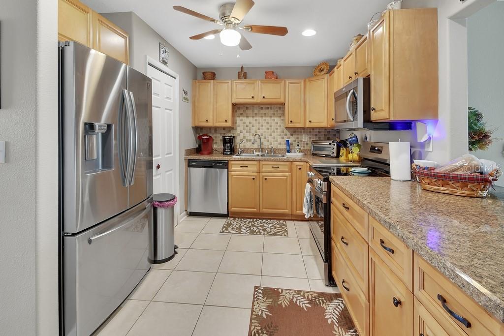 50 Bonita Road DeBary, FL 32713 - Photo 3 of 43 a kitchen with stainless steel appliances granite countertop a refrigerator a stove top oven a sink and dishwasher