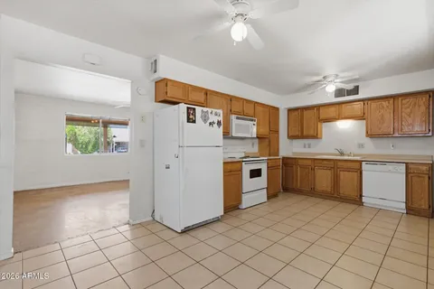 a kitchen with stainless steel appliances a refrigerator sink and microwave