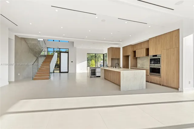 a view of kitchen with furniture and refrigerator