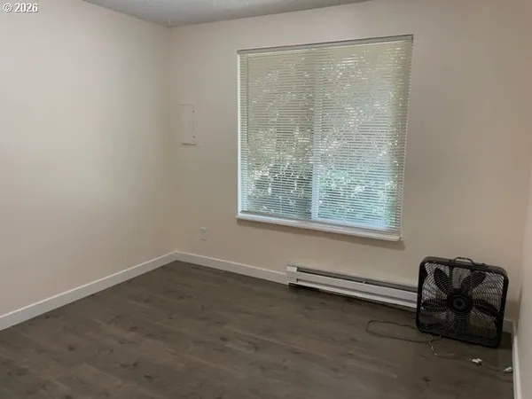 a room with a window and a wooden floor