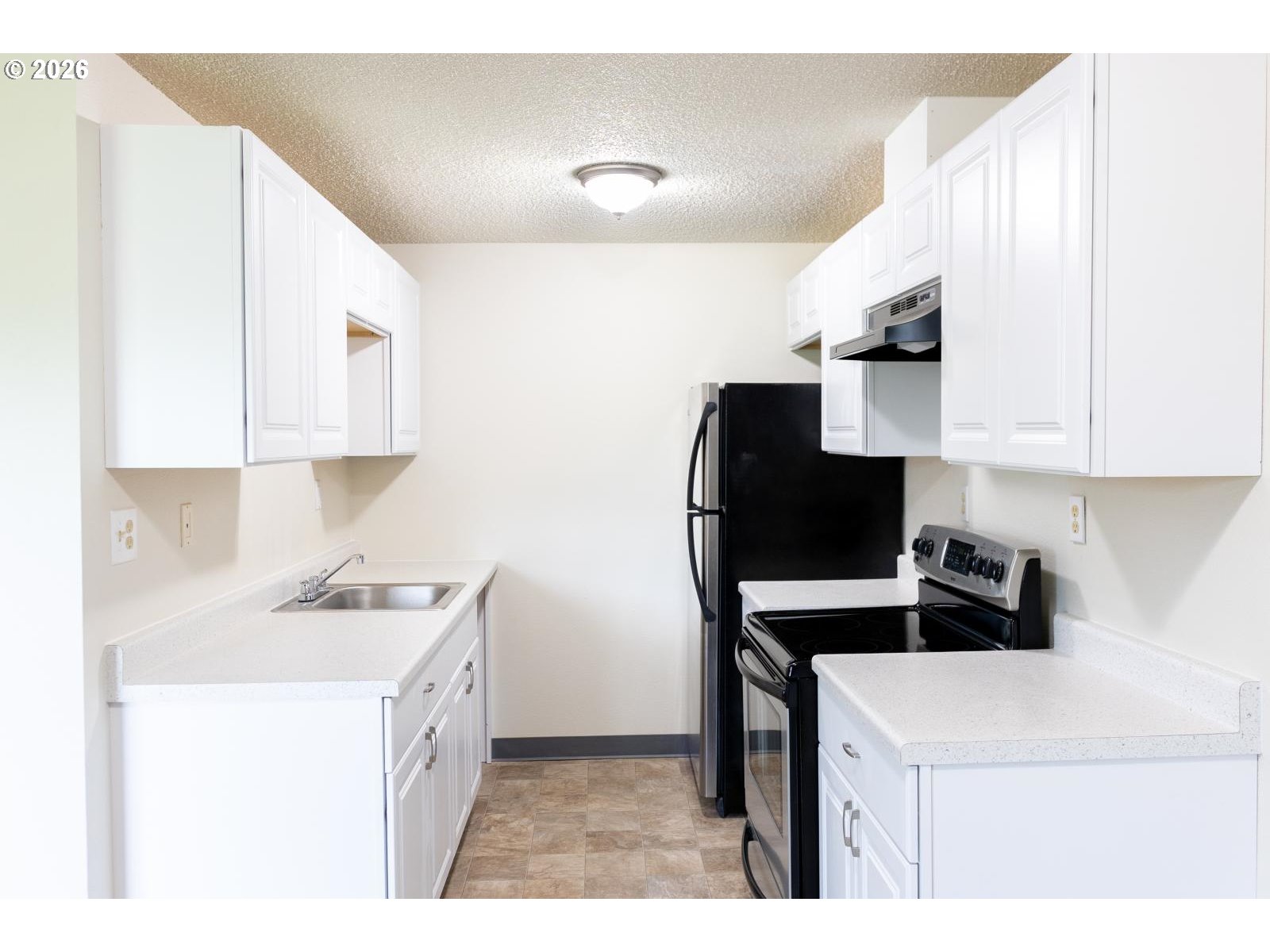8856 Southeast Jannsen Road Clackamas, OR 97015 - Photo 18 of 28 a kitchen with a sink a stove and cabinets