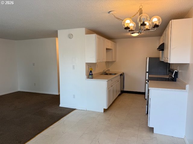 8856 Southeast Jannsen Road Clackamas, OR 97015 - Photo 21 of 28 a view of kitchen with granite countertop cabinets and refrigerator