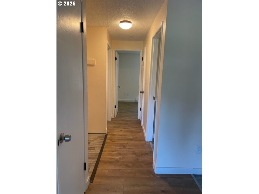 8856 Southeast Jannsen Road Clackamas, OR 97015 - Photo 9 of 28 a view of a hallway with wooden floor