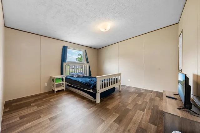 a bedroom with furniture and a flat screen tv