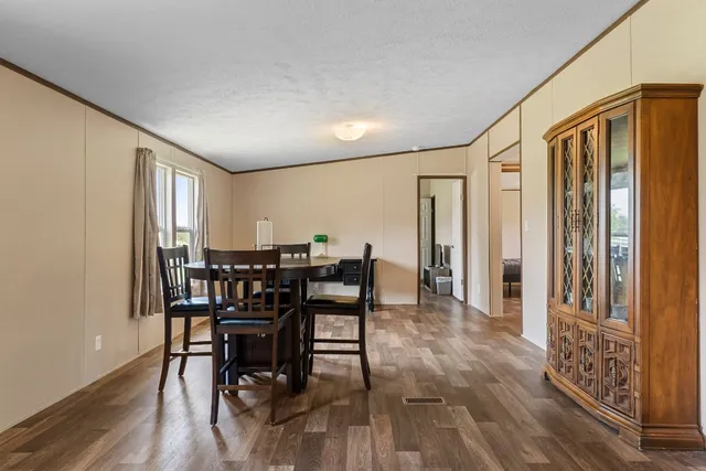 a view of a a dining room with furniture window and wooden floor