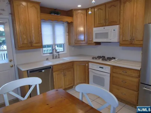 a kitchen with a refrigerator sink and stove