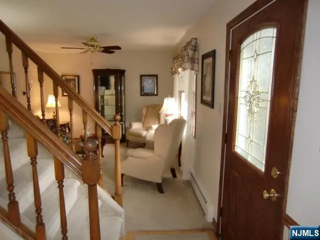 a view of staircase with furniture and windows