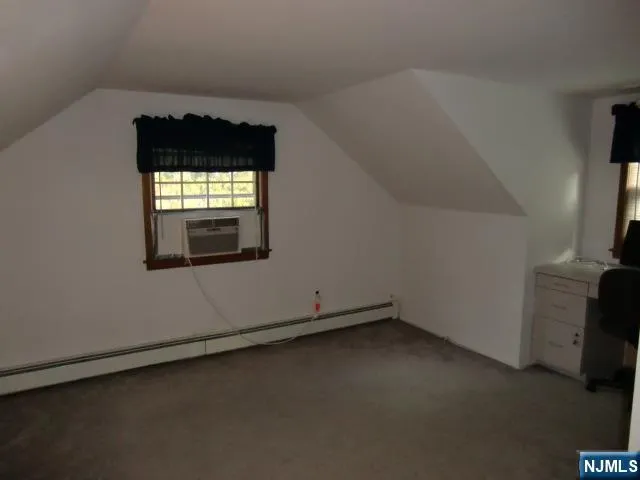 a view of a livingroom with wooden floor and a fireplace