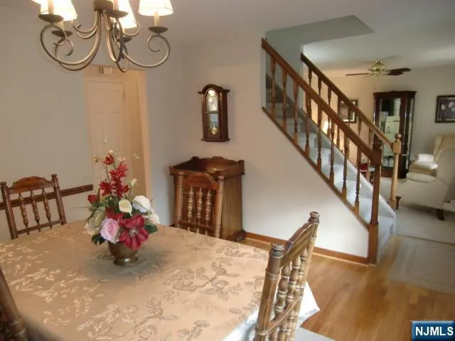 a view of a dining room with furniture and chandelier