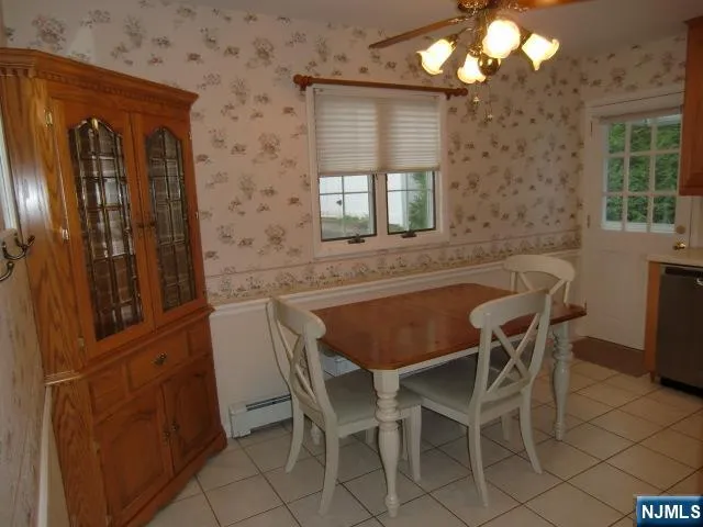 a kitchen with a table chairs sink and cabinets