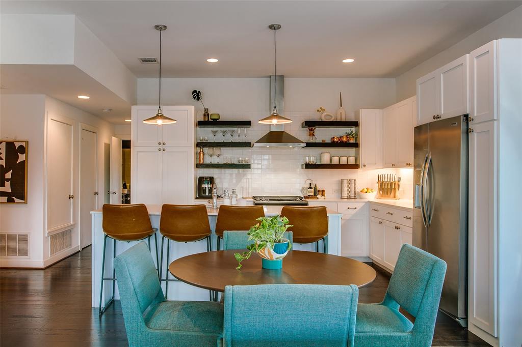 603 Finley Court Dallas, TX 75208 - Photo 12 of 40 a kitchen with stainless steel appliances kitchen island granite countertop a dining table chairs refrigerator and microwave