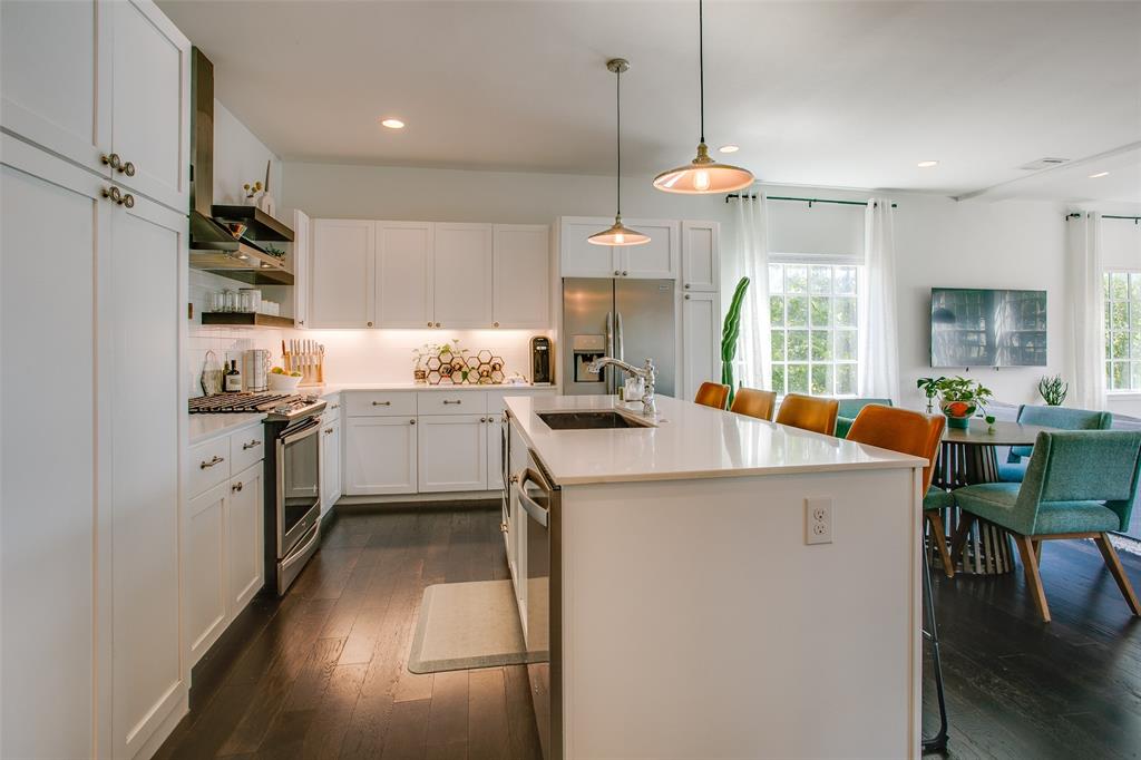 603 Finley Court Dallas, TX 75208 - Photo 9 of 40 a kitchen that has a lot of cabinets and wooden floor