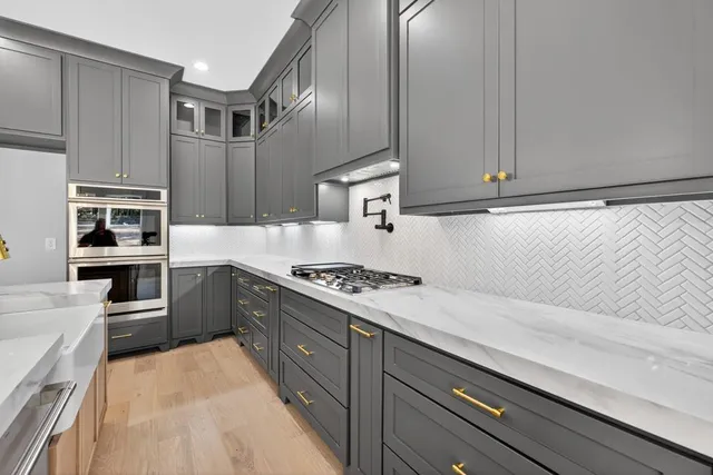 a view of a livingroom with wooden floor and a ceiling fan
