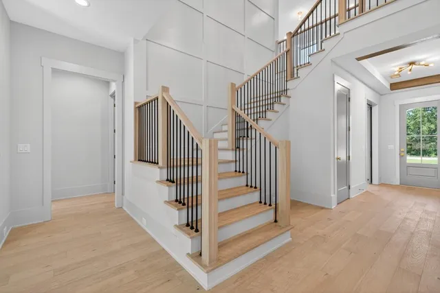 a kitchen with stainless steel appliances granite countertop a sink a stove and a wooden floors