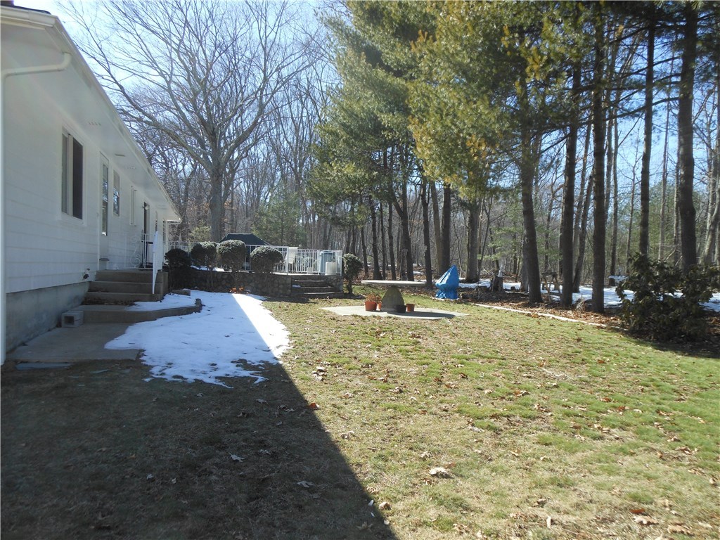 17 Hawthorne Road Smithfield, RI 02828 - Photo 6 of 22 Exterior rear with patio and abutting woods