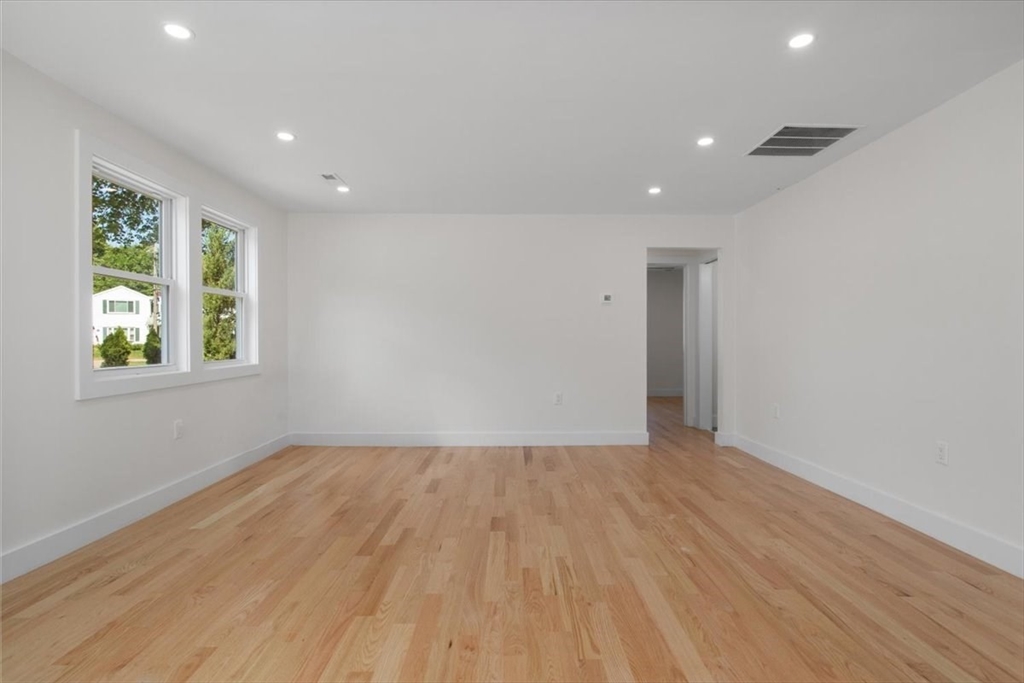 3 Cummings Circle Randolph, MA 02368 - Photo 18 of 39 an empty room with wooden floor and windows