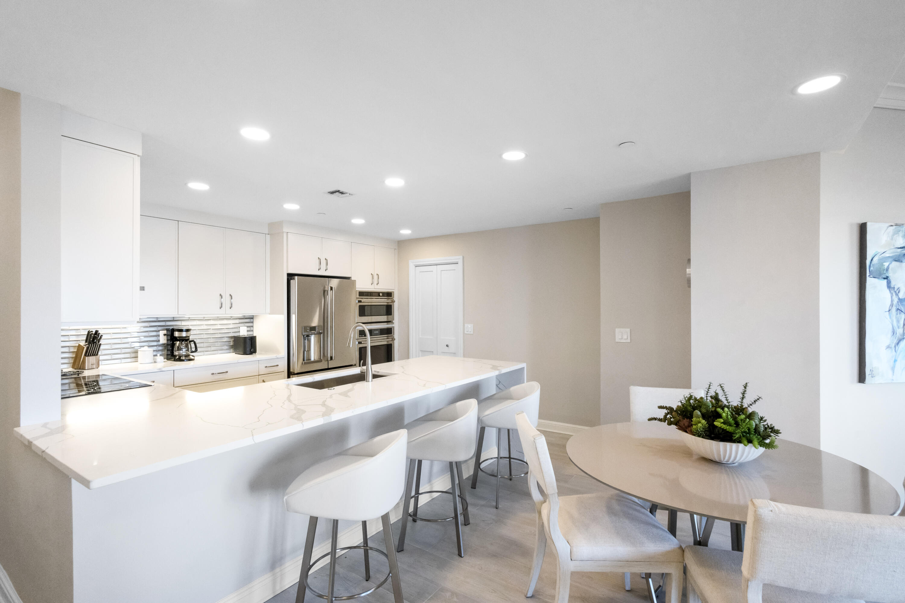 8708 Anchorage Drive Miramar Beach, FL 32550 - Photo 12 of 43 a kitchen with kitchen island a sink table and chairs