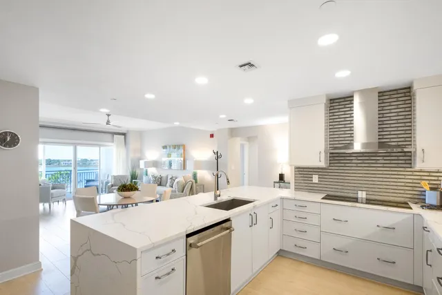 a kitchen with sink stove and cabinets
