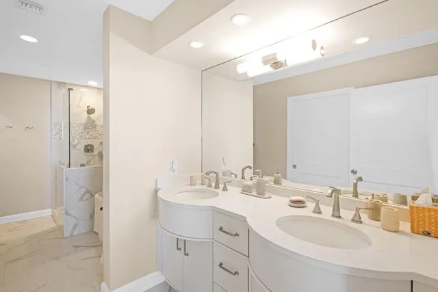 a bathroom with a sink double vanity and a mirror