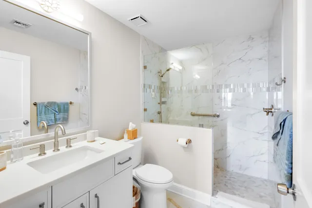 a bathroom with a sink toilet tub and shower