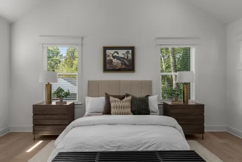 a bedroom with a bed and wooden floor