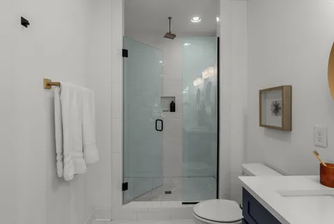 a bathroom with a sink toilet and shower