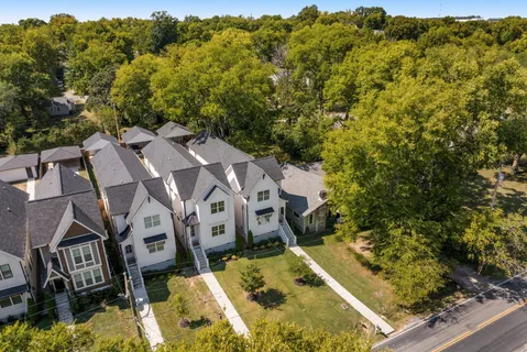 an aerial view of residential houses with outdoor space