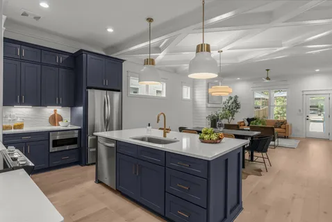 a kitchen with kitchen island a sink stove and refrigerator