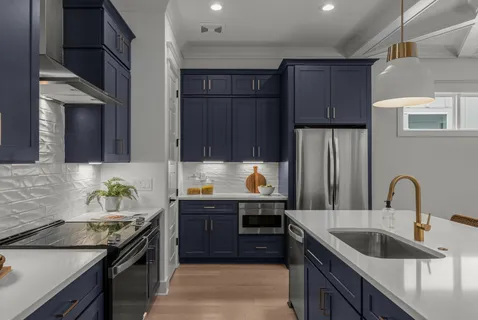 a kitchen with kitchen island granite countertop a sink stove and refrigerator