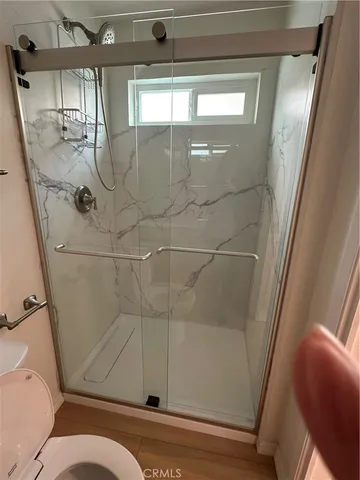 a bathroom with a toilet a sink and shower