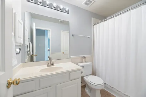 a bathroom with a sink a toilet and a mirror