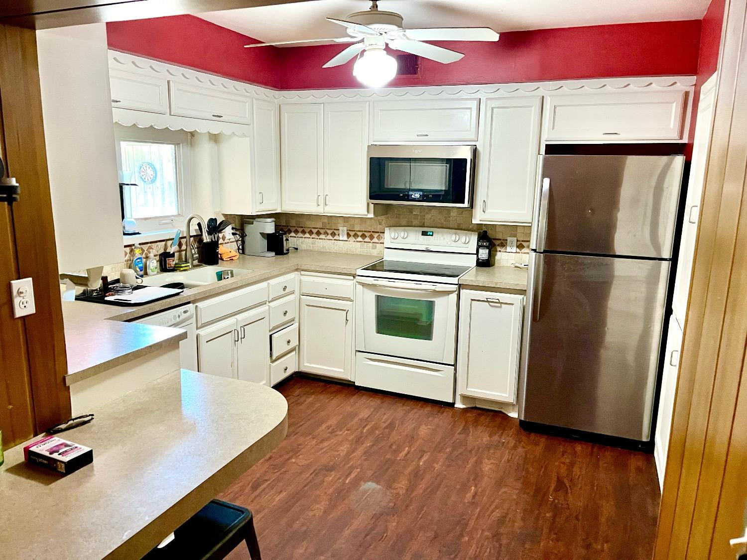 2621 23rd Street Lubbock, TX 79410 - Photo 10 of 38 a kitchen with a sink stainless steel appliances and white cabinets