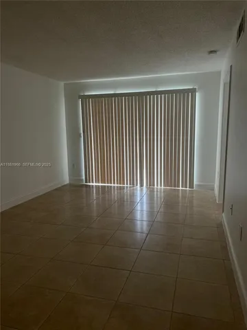 a view of a livingroom with wooden floor and a window