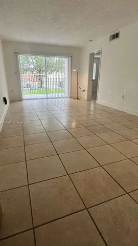 a kitchen with a sink and white cabinets