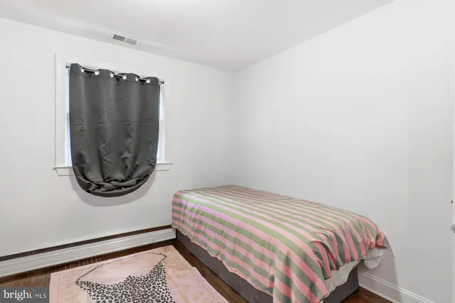 a bedroom with a bed and a mirror