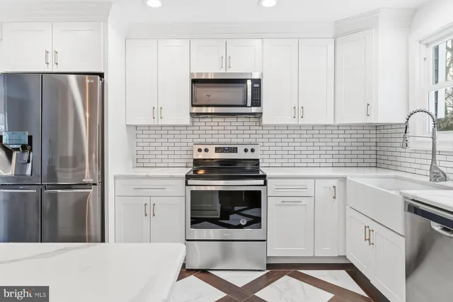 a kitchen with cabinets and stainless steel appliances