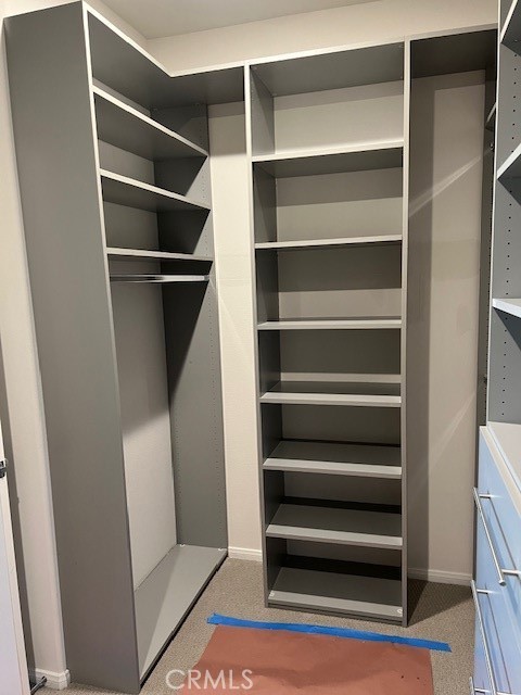 29901 Bridlegate Way Menifee, CA 92584 - Photo 18 of 43 a view of walk in closet with empty racks