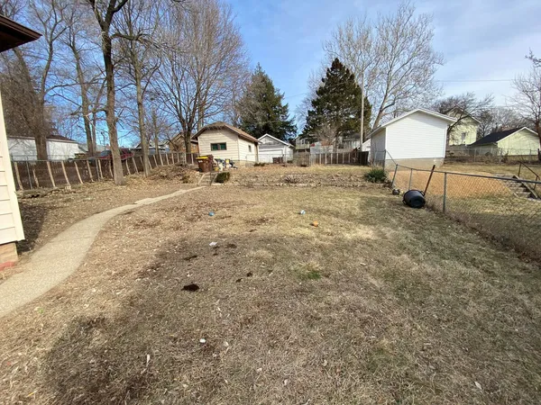 a view of a yard with snow on the road