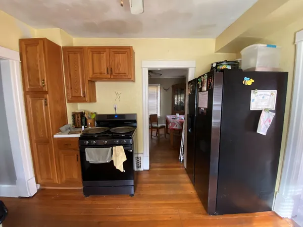 a kitchen with stainless steel appliances granite countertop a refrigerator and a stove
