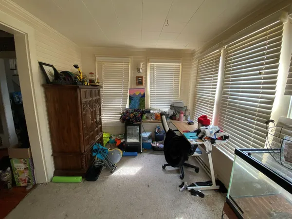 a view of a workspace with furniture and a window