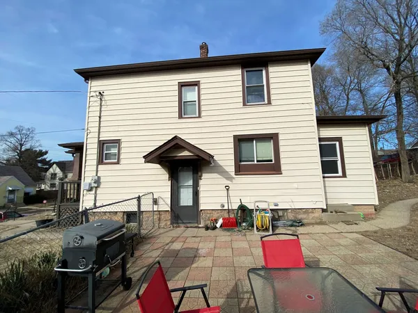 a view of house with backyard