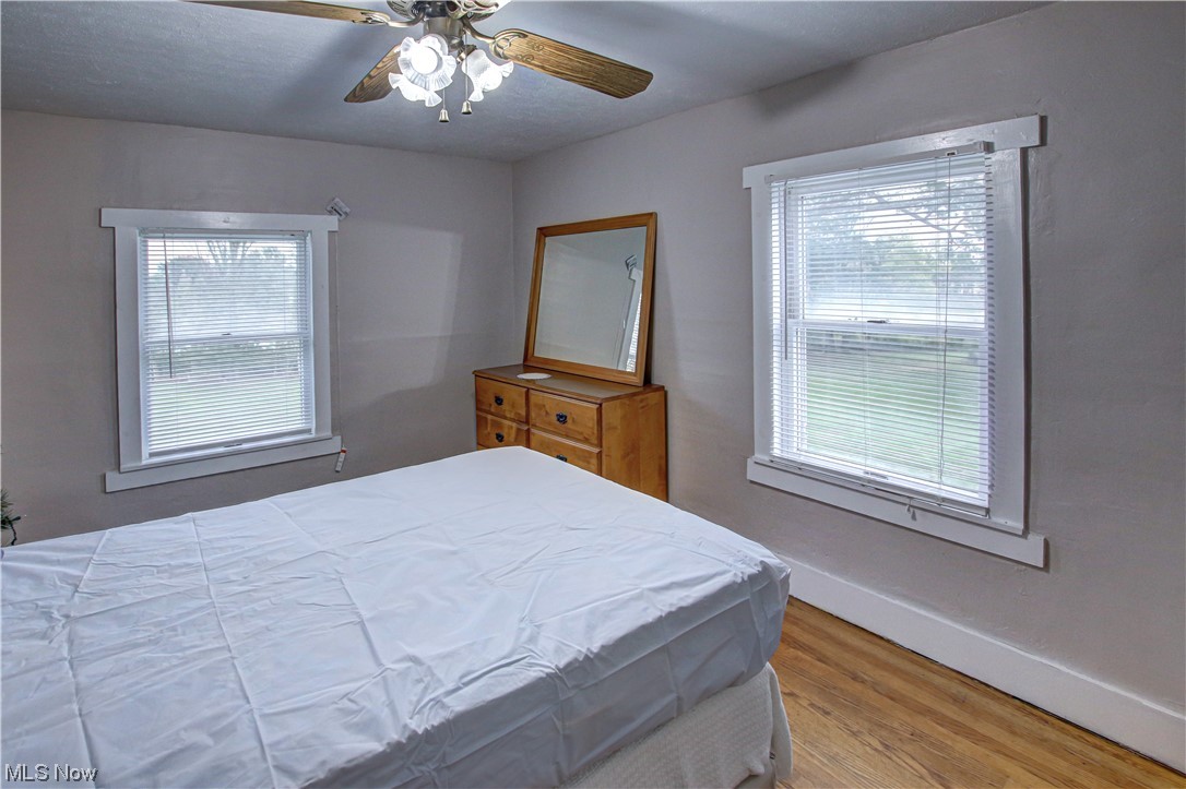 3946 Poe Road Medina, OH 44256 - Photo 22 of 35 Bedroom featuring multiple windows, light hardwood floors, and ceiling fan