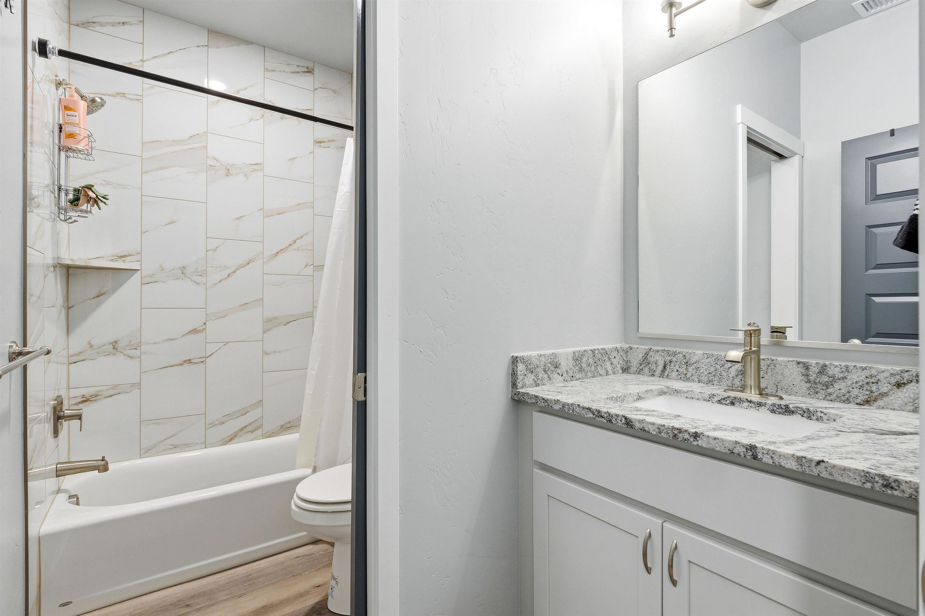 2459 Hamilton Road, Unit A Grand Junction, CO 81505 - Photo 20 of 27 a bathroom with a granite countertop sink and a bathtub