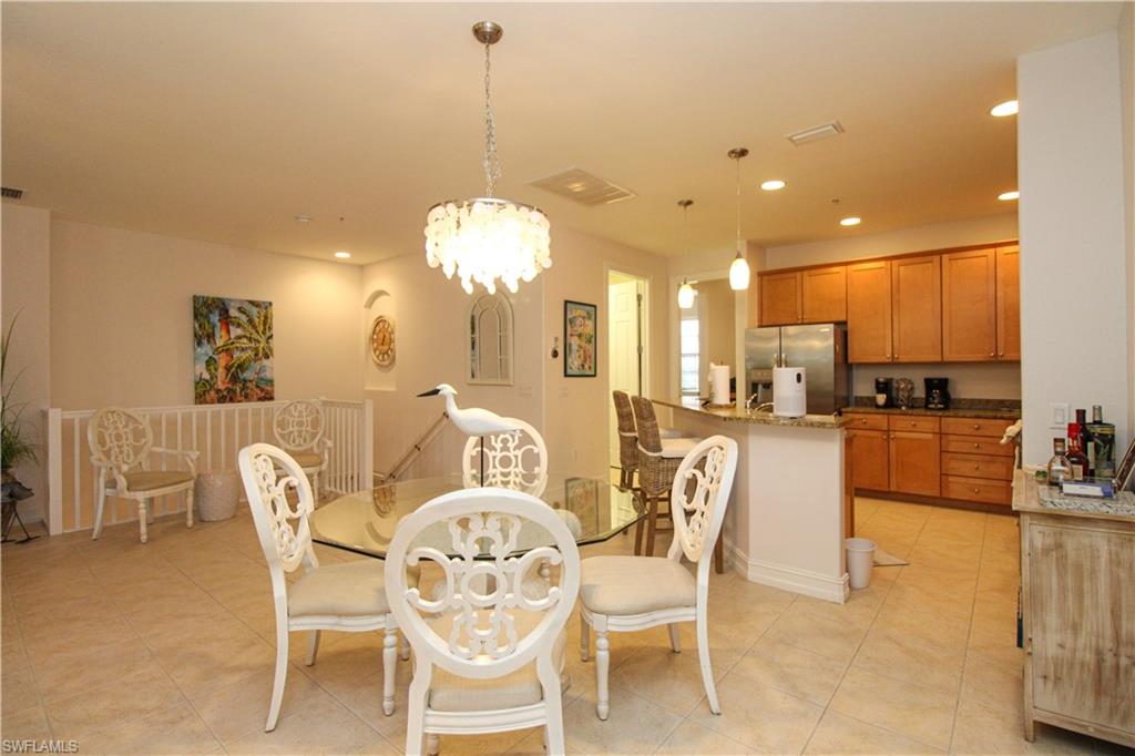 9159 Delano Street, Unit 9905 Naples, FL 34113 - Photo 11 of 44 Dining space featuring a chandelier and light tile patterned floors