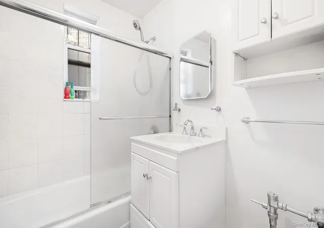 a bathroom with a sink a mirror and a shower