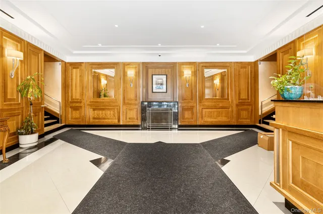 a view of a livingroom with furniture staircase and windows