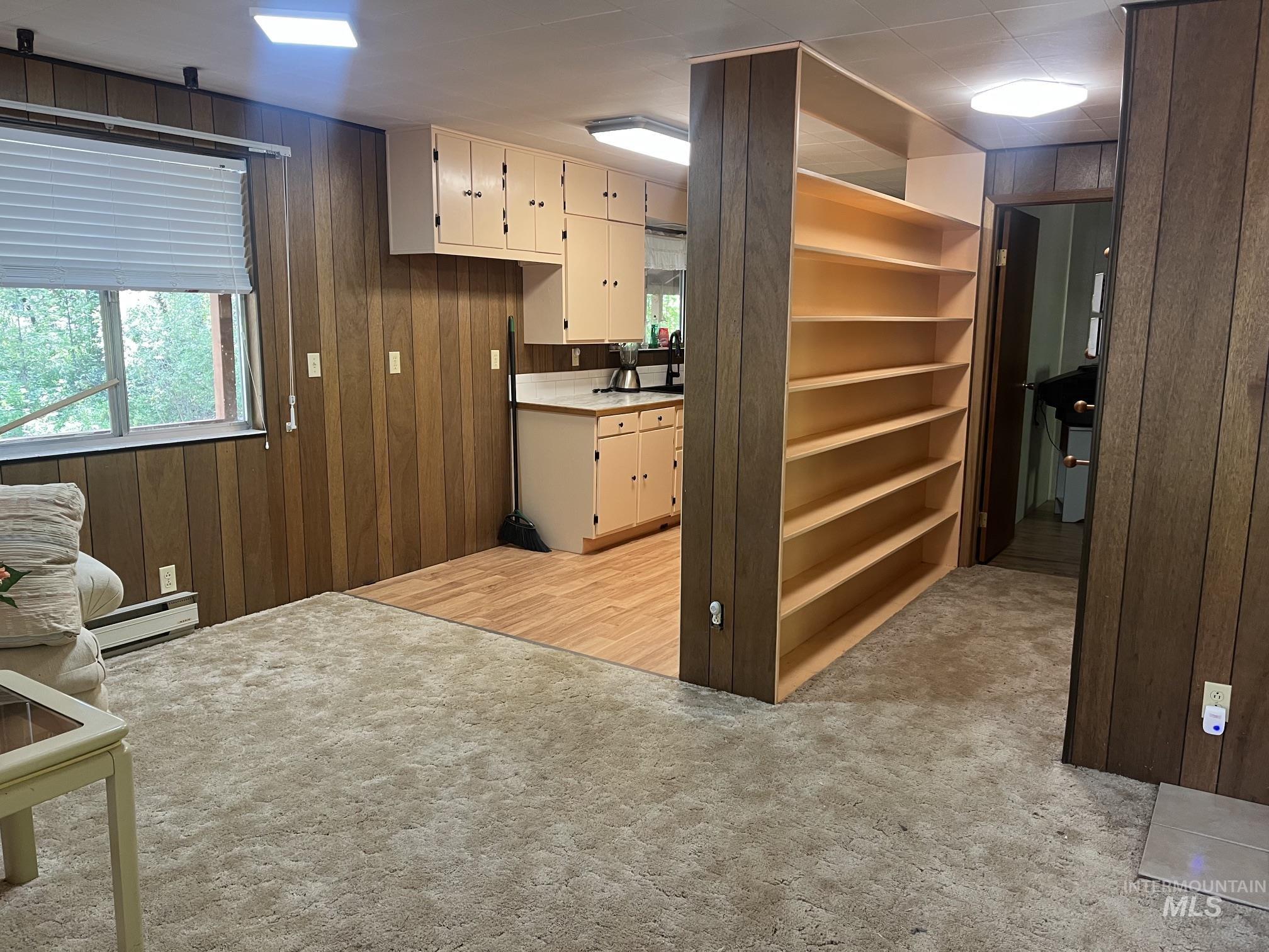 39 Mayflower Mine Road Placerville, ID 83666 - Photo 17 of 36 Open concept living area with wood-finish paneling and plush carpeting
