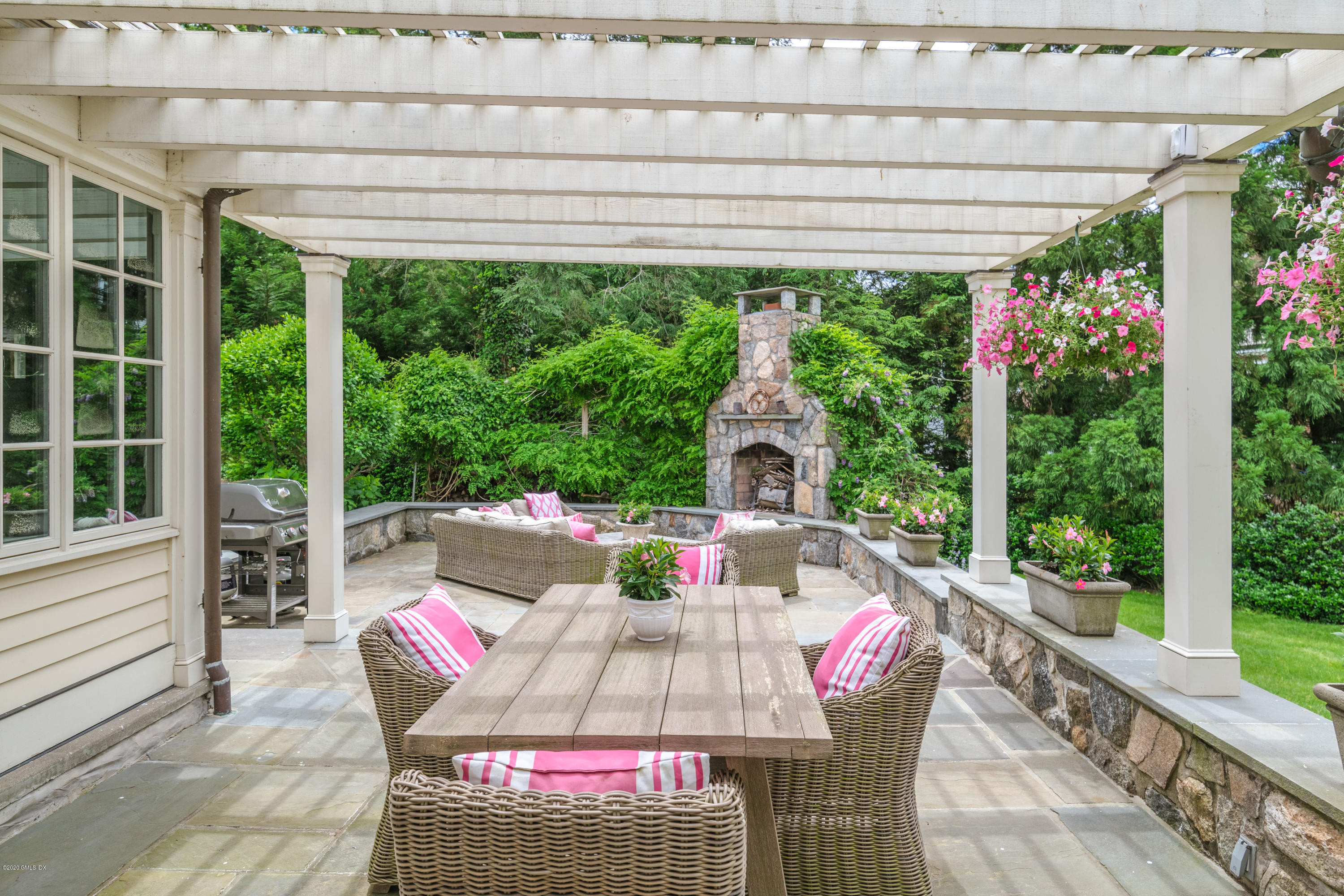 18 Tower Road Riverside, CT 06878 - Photo 16 of 27 a view of a patio with table and chairs potted plants with wooden floor and fence
