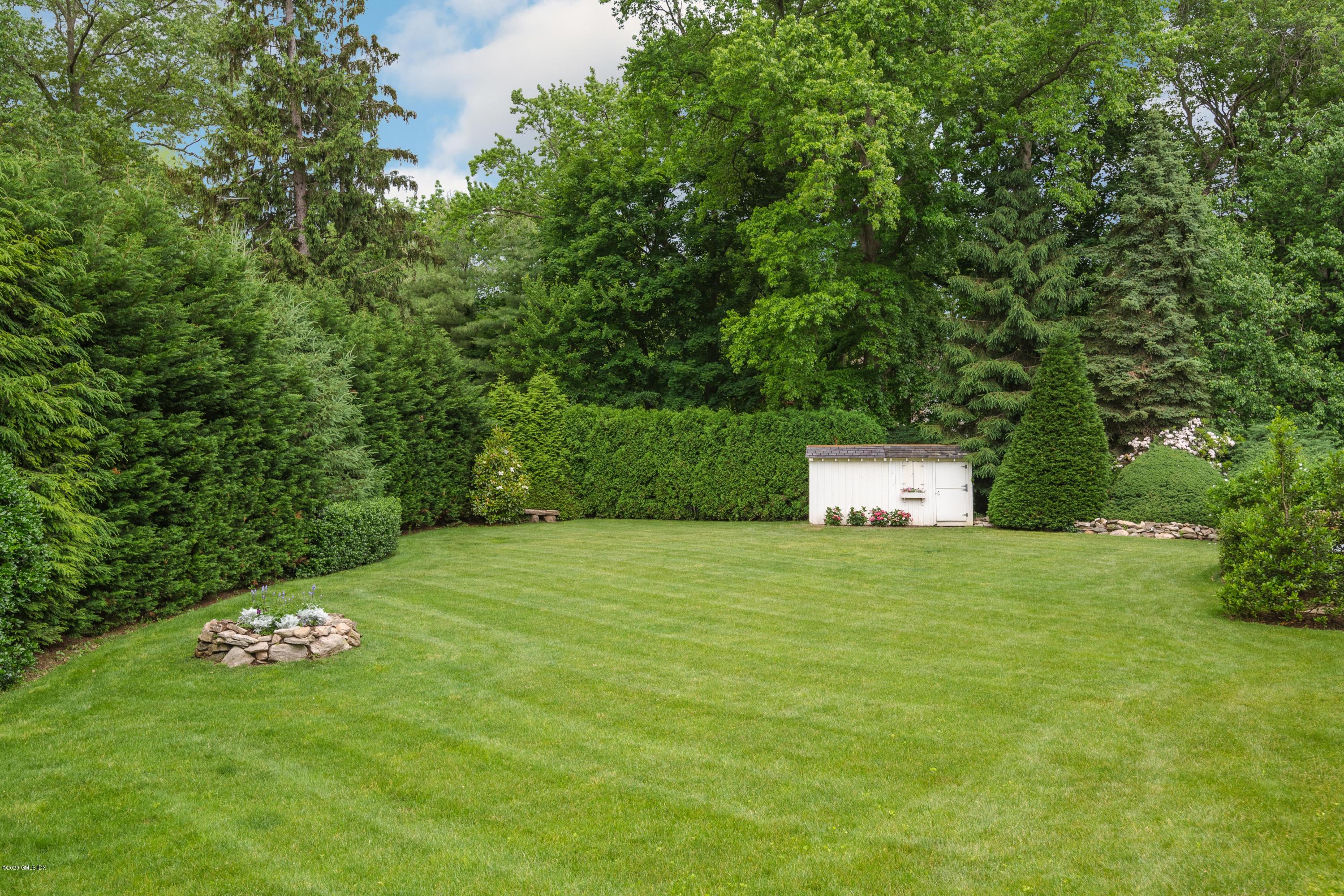 18 Tower Road Riverside, CT 06878 - Photo 21 of 27 a house with a tree in a backyard